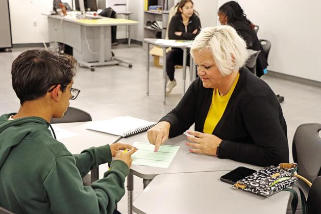 MPHS teacher, Misty McCrumby (right), helps a new student choose courses for his freshman year (COURTESY PHOTOS)